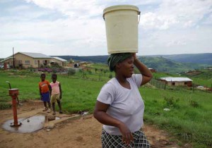 wozawomanbucketlo Water is pumped by hand and carried back home.