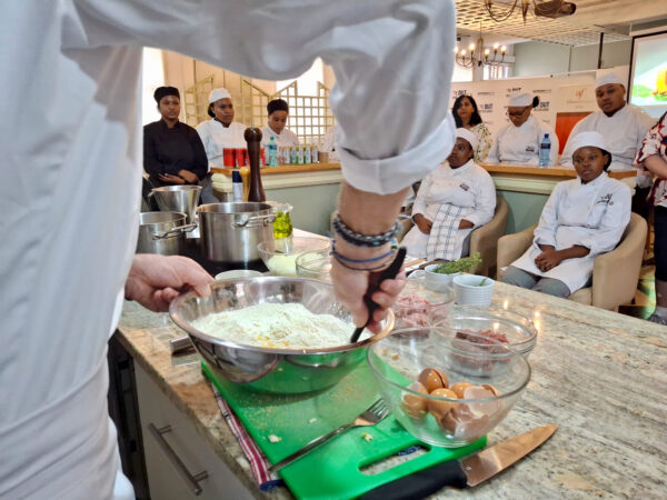 Chef Husser shows students how